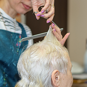 Resident having hair cut