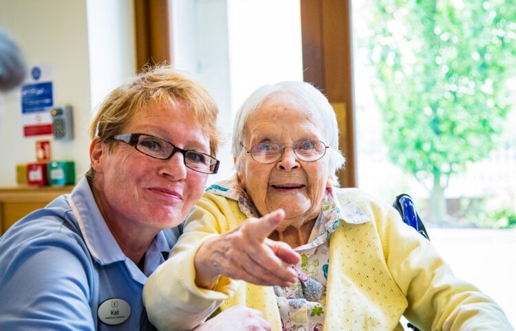 Resident pointing with carer
