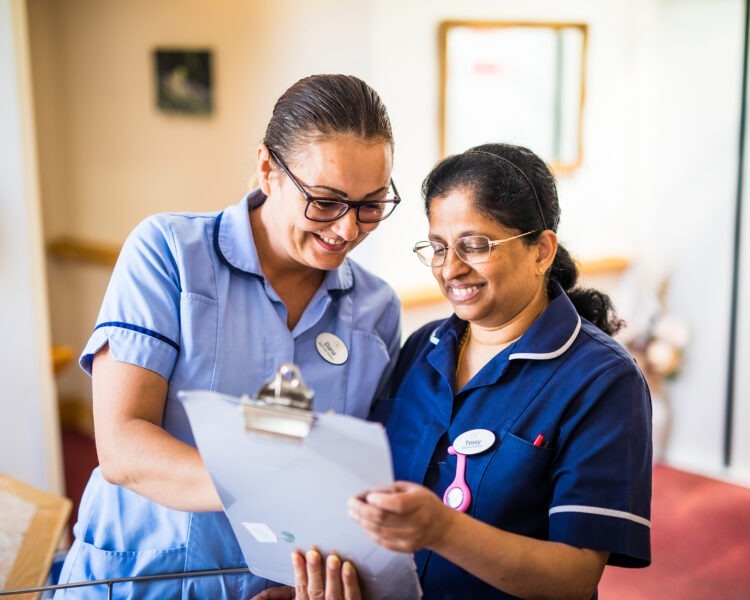 Nurse and a carer looking at a care plan